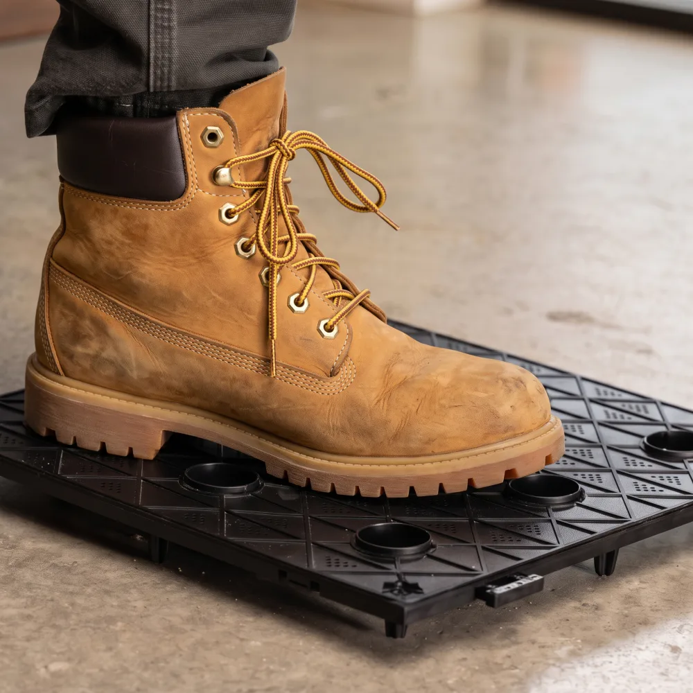 A boot stepping on a load-bearing PhytoMat Structural tile